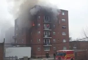 Firefighters battling a blaze in an apartment building in New York City