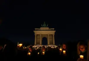 Participants holding candles during a vigil at Stonewall National Monument
